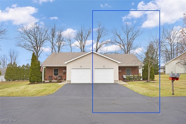 view of front of property with a garage and a front lawn