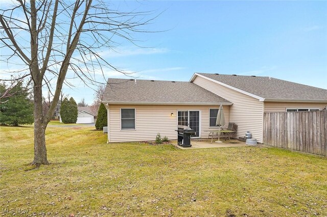 back of house featuring a lawn and a patio area