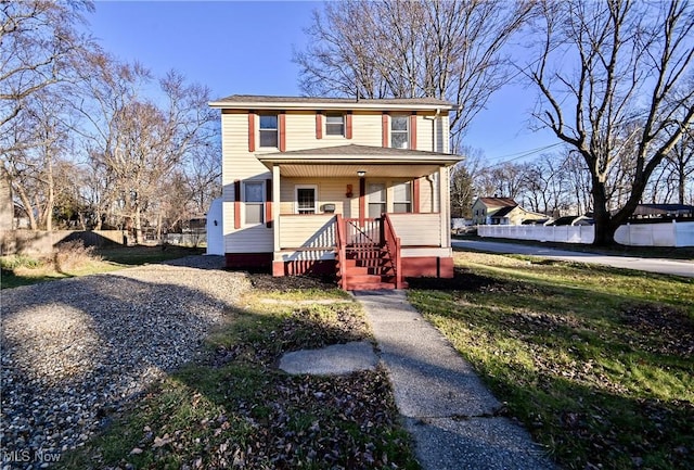 view of front property featuring covered porch and a front yard