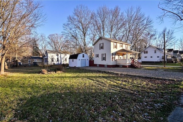 view of property exterior with a yard, a porch, and a storage shed