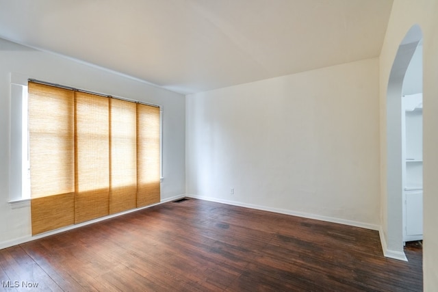 unfurnished room with dark hardwood / wood-style flooring