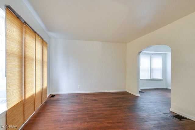 unfurnished bedroom with dark hardwood / wood-style floors and a closet