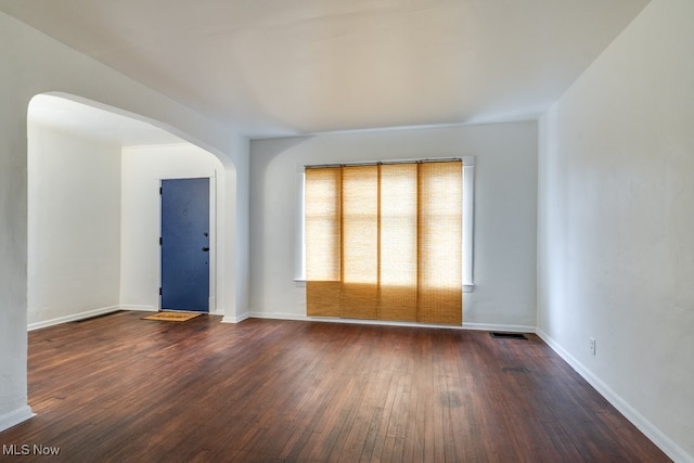 spare room with dark hardwood / wood-style floors