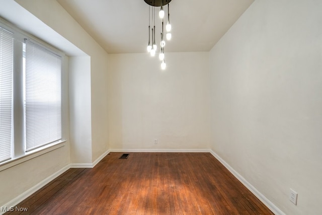 spare room featuring dark hardwood / wood-style flooring