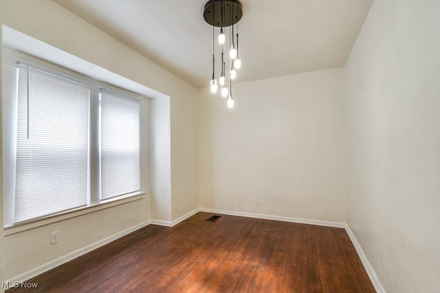 unfurnished room featuring dark hardwood / wood-style flooring