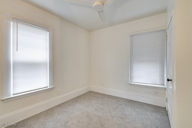 unfurnished room with ceiling fan and light colored carpet