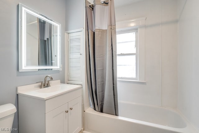 full bathroom featuring shower / bath combo, vanity, and toilet