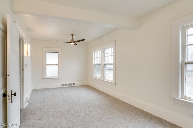 carpeted spare room with ceiling fan and a healthy amount of sunlight