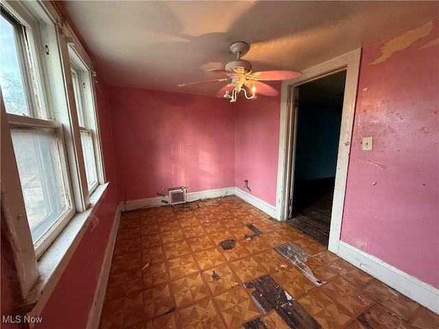 spare room featuring ceiling fan and parquet flooring