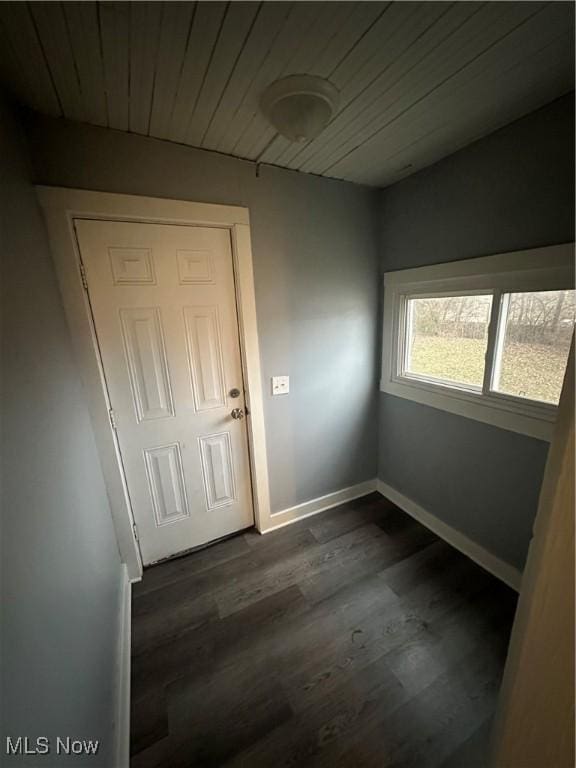 interior space with wood ceiling and dark hardwood / wood-style floors