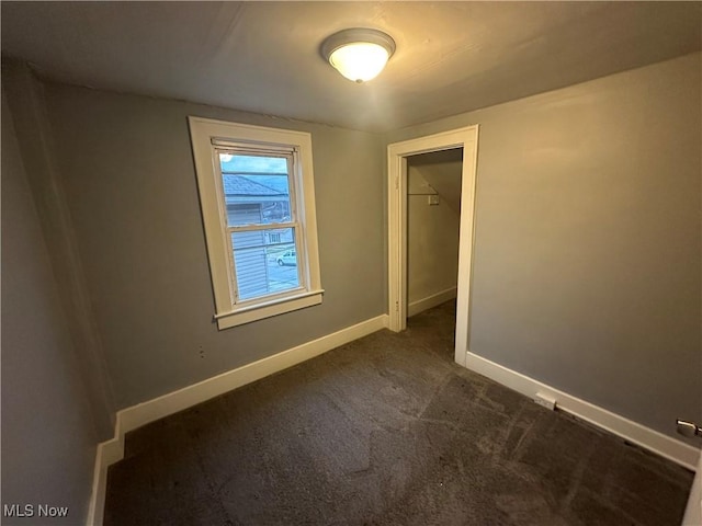 empty room with dark carpet