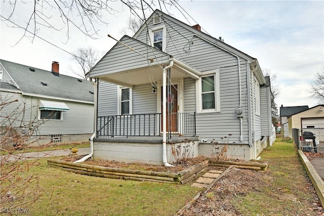 bungalow-style home featuring a front yard and a porch