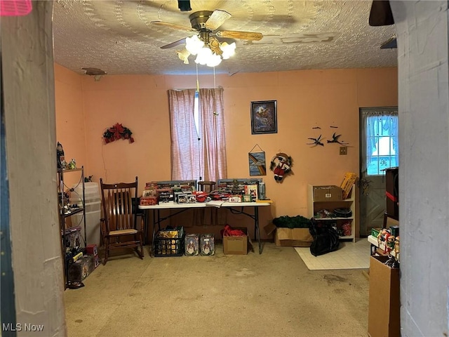 dining room featuring ceiling fan and a textured ceiling