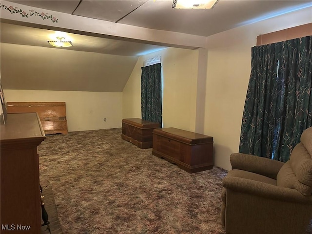 living room featuring dark carpet and lofted ceiling