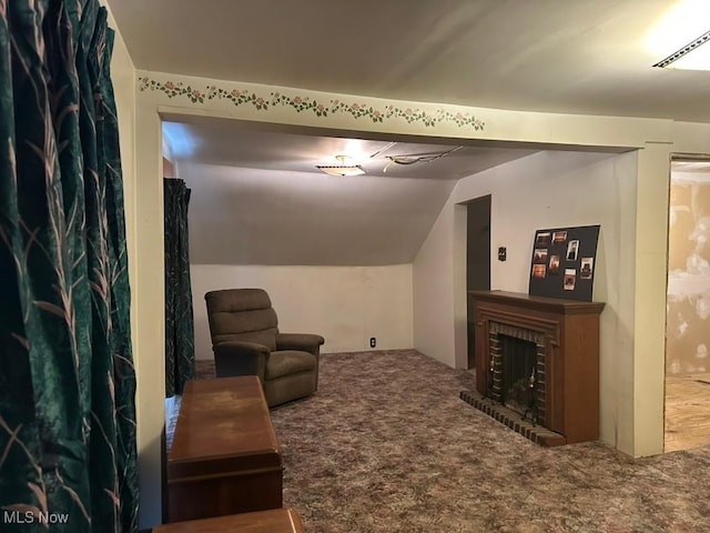 living area with carpet flooring, a fireplace, and lofted ceiling