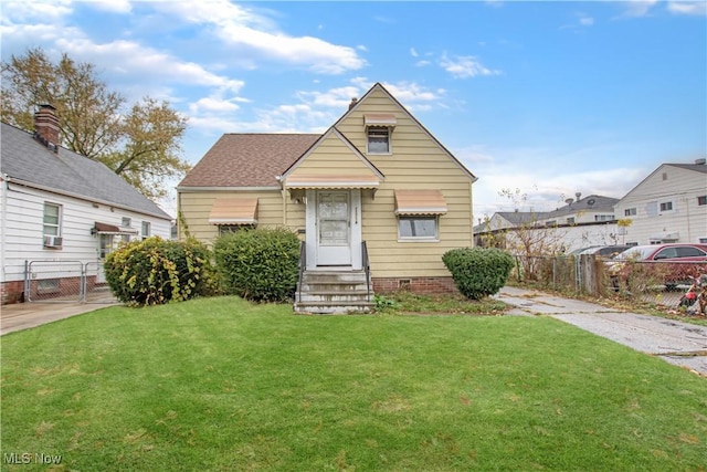 bungalow-style house with a front lawn