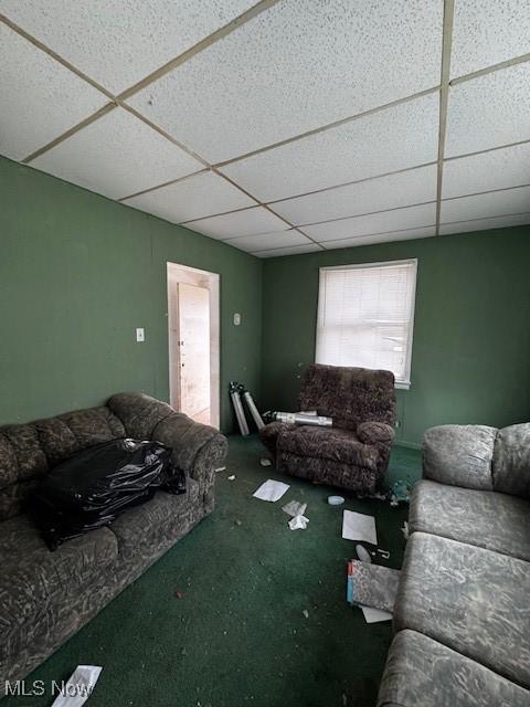 living room with a drop ceiling