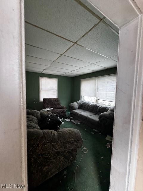 living room with a drop ceiling