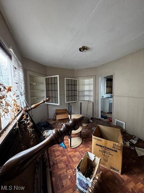 miscellaneous room featuring parquet flooring