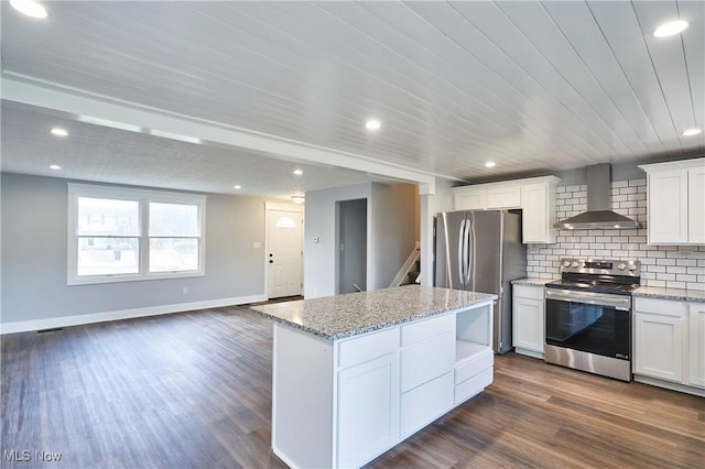 kitchen featuring wall chimney exhaust hood, stainless steel appliances, white cabinets, a center island, and dark hardwood / wood-style floors