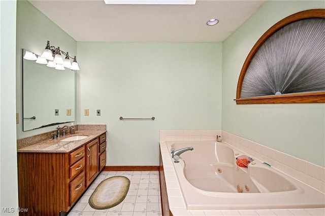 bathroom featuring vanity and tiled tub