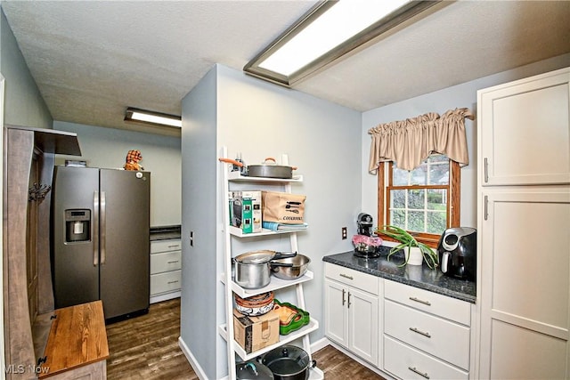 kitchen with white cabinetry, stainless steel refrigerator with ice dispenser, and dark wood-type flooring