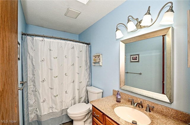 bathroom with a shower with curtain, vanity, a textured ceiling, and toilet