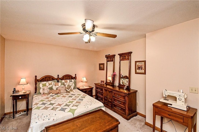 carpeted bedroom with ceiling fan and a textured ceiling