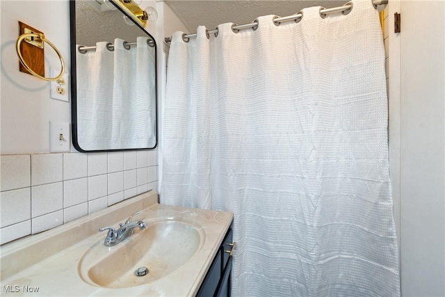 bathroom featuring vanity and backsplash