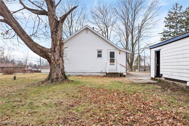 view of property exterior featuring a lawn