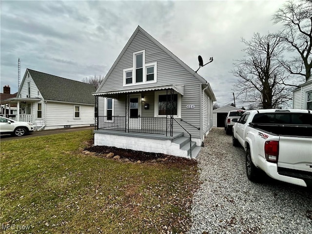 view of front of home featuring covered porch and a front yard