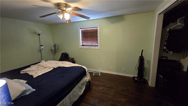 bedroom with ceiling fan and dark wood-type flooring