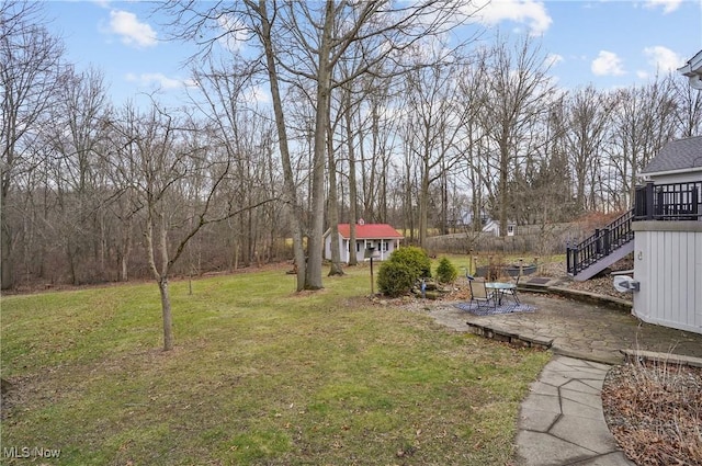 view of yard with a deck and a patio area