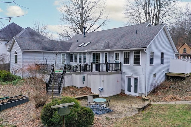 back of house with a patio area, a wooden deck, and french doors