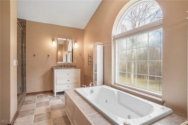 bathroom featuring shower with separate bathtub, vanity, and lofted ceiling