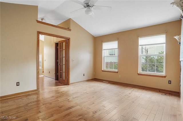 spare room featuring ceiling fan, light hardwood / wood-style flooring, and lofted ceiling