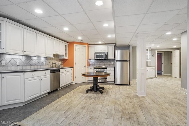 kitchen featuring white cabinets, light hardwood / wood-style floors, and appliances with stainless steel finishes