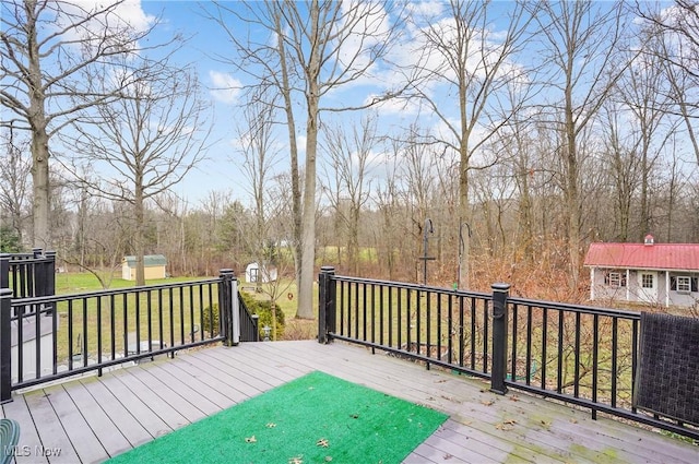 deck with a yard and a shed