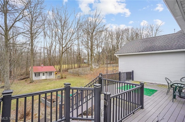 wooden terrace with a yard and a storage shed