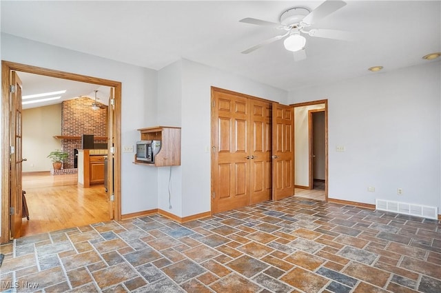 spare room with ceiling fan and lofted ceiling