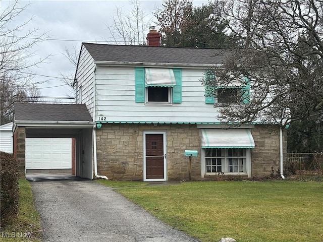 view of front of house with a front yard and a garage