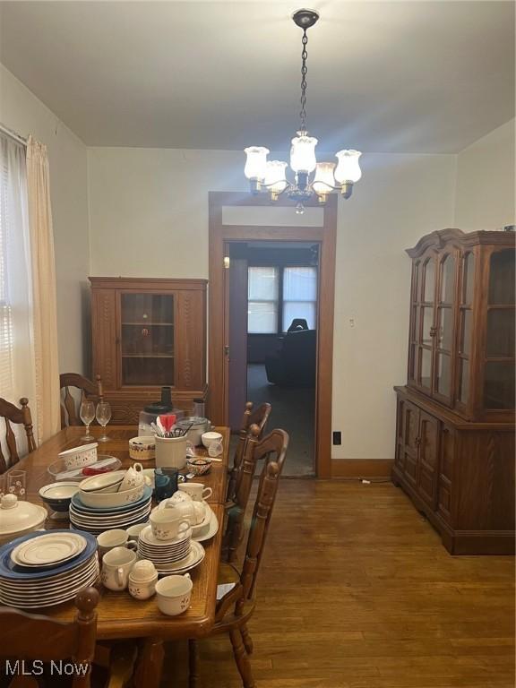 dining space featuring a chandelier and wood-type flooring