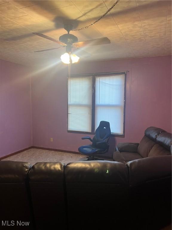 living room with ceiling fan and carpet floors