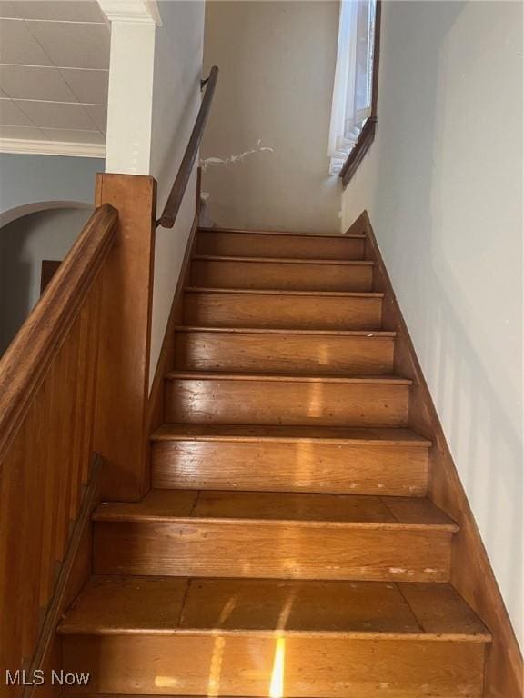 stairway featuring crown molding