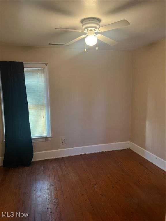 unfurnished room featuring ceiling fan and dark hardwood / wood-style flooring