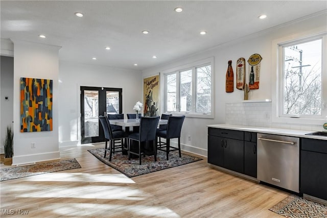 dining space with light hardwood / wood-style floors and crown molding