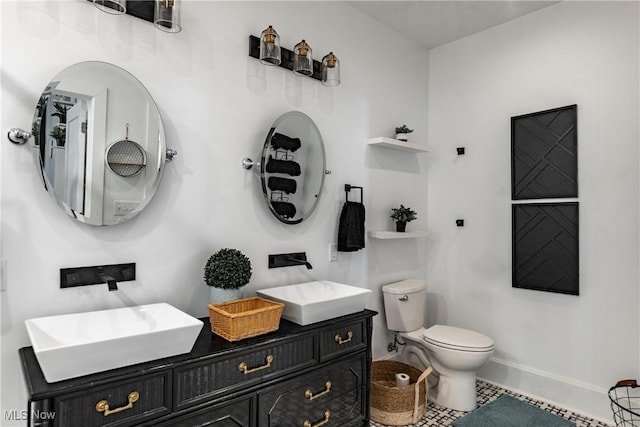 bathroom featuring tile patterned floors, vanity, and toilet