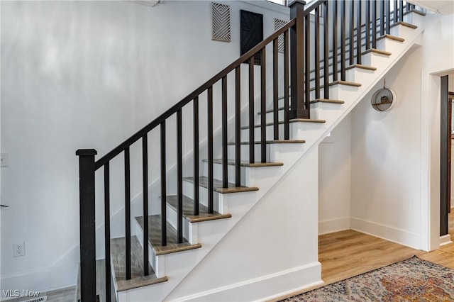 stairs with hardwood / wood-style floors