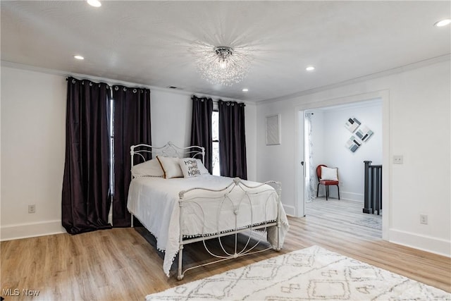 bedroom with light hardwood / wood-style flooring and ornamental molding