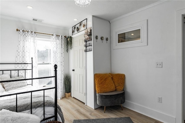 bedroom featuring light hardwood / wood-style flooring and ornamental molding